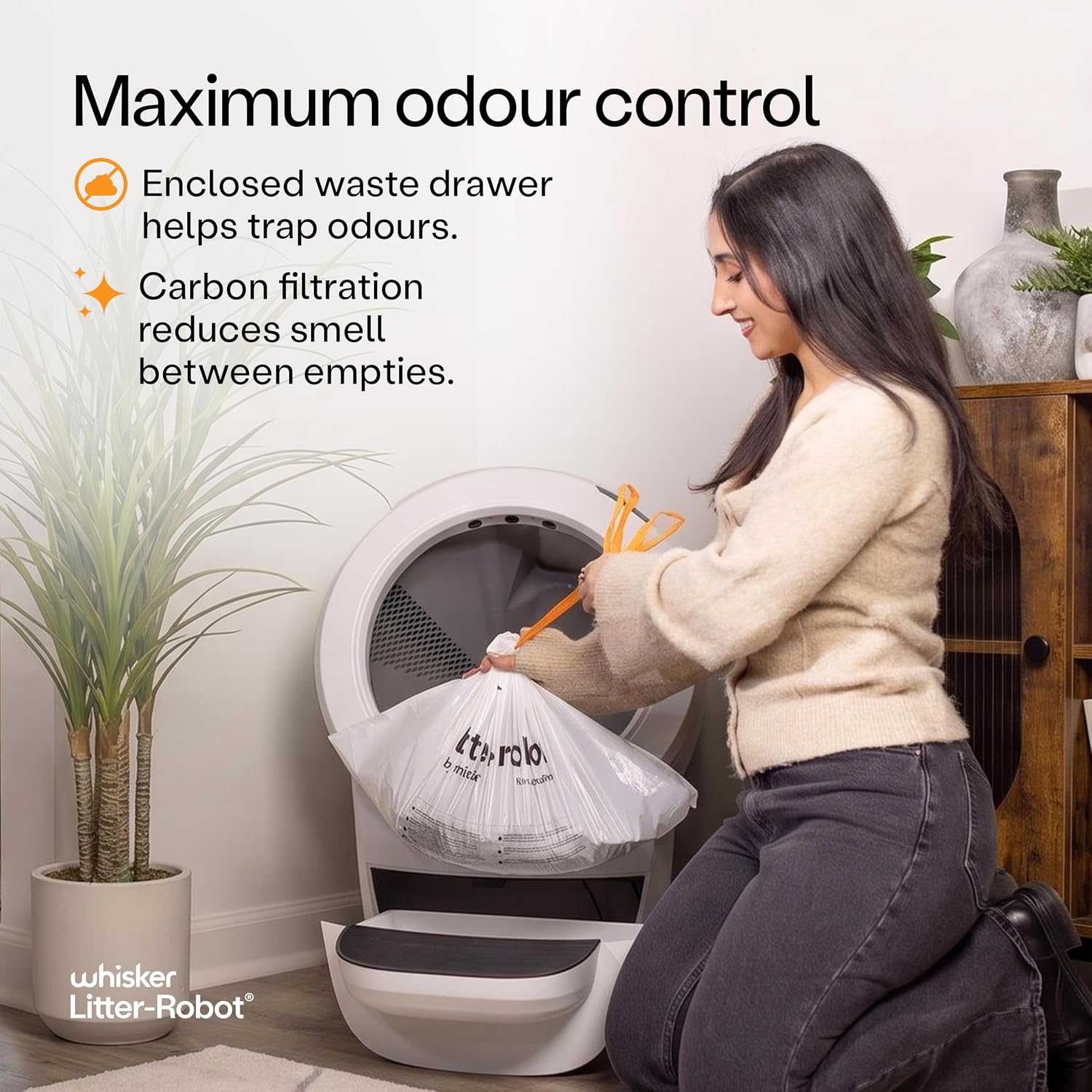 Owner emptying the enclosed Litter-Robot 4 waste drawer