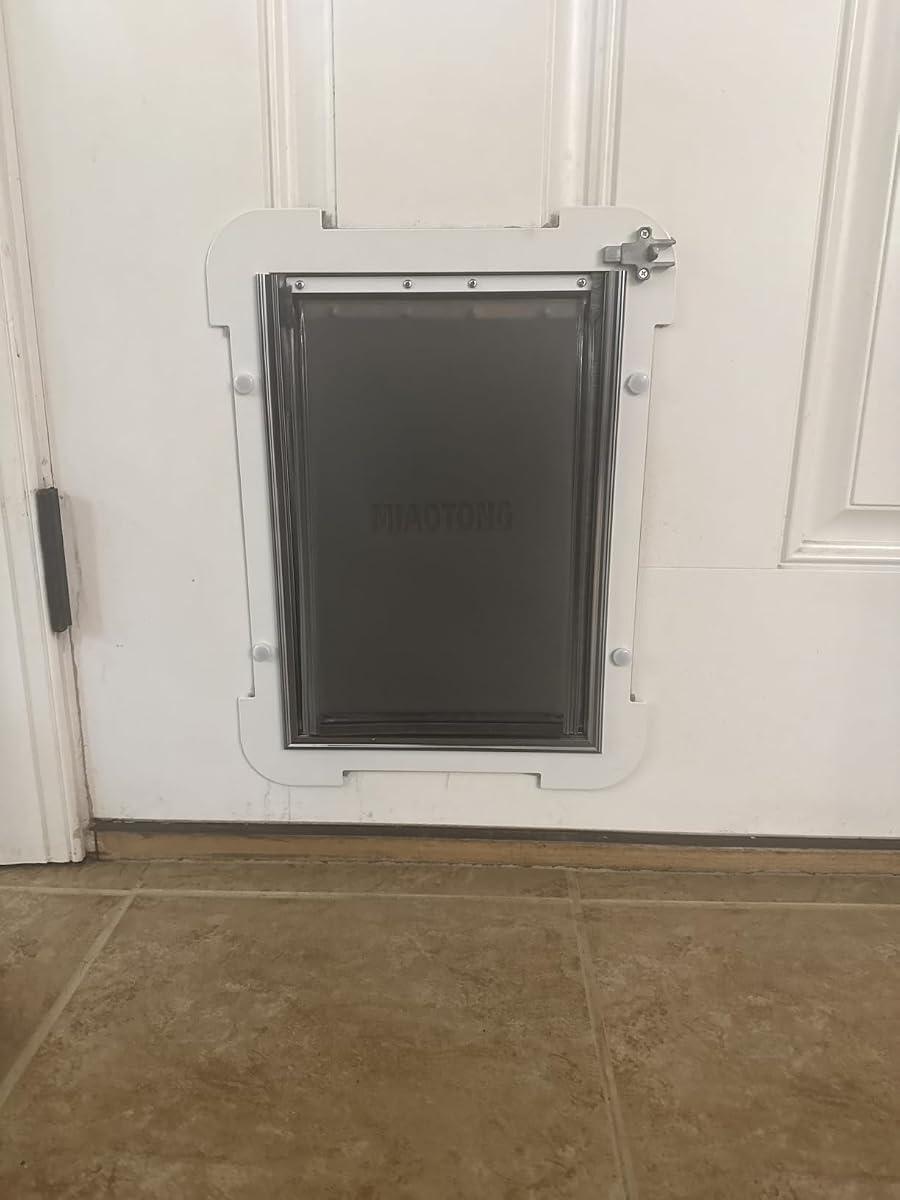 MIAOTONG dog door seen from inside the house with the metal sliding lock panel
