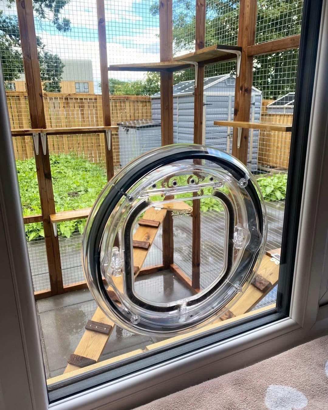 Cat flap installed in a window with catio outside