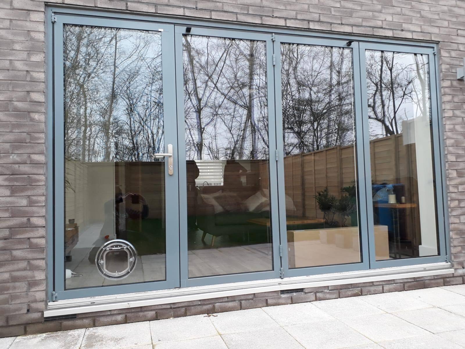Cat flap fitted into a glazed aluminium door