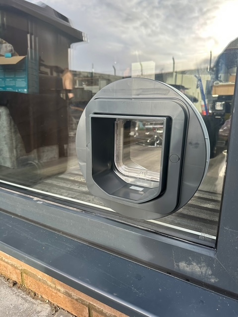 SureFlap cat flap in anthracite grey glass door frame
