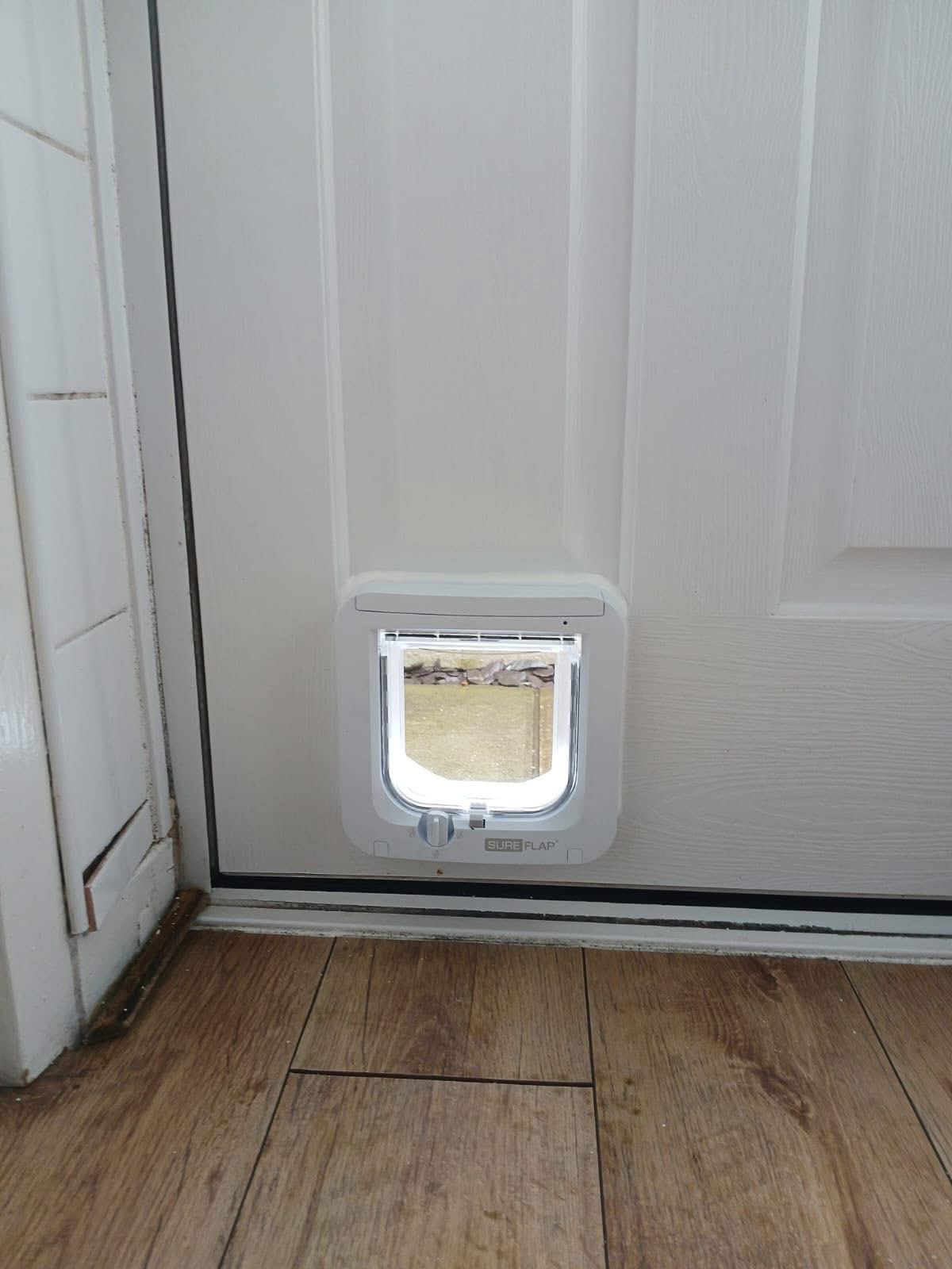 SureFlap cat flap installed in a white UPvc door panel
